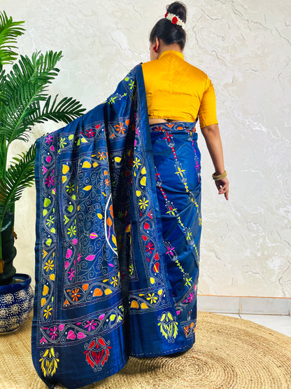 Back standing view of ink blue Kantha stitch saree with swan and floral border