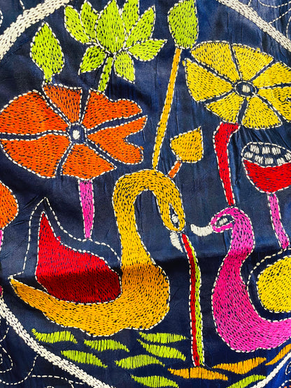 Close-up of hand-stitched swan medallion motif on ink blue Kantha saree