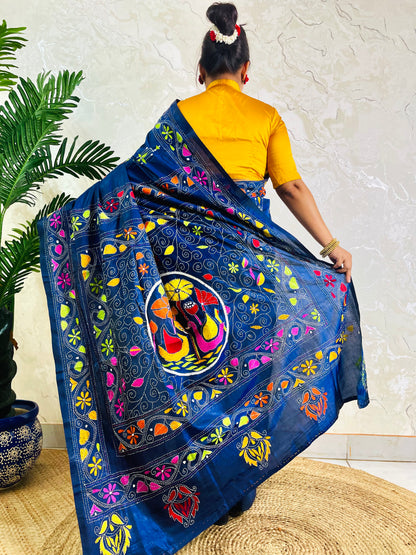 Back standing view of ink blue Kantha stitch saree with swan and floral border