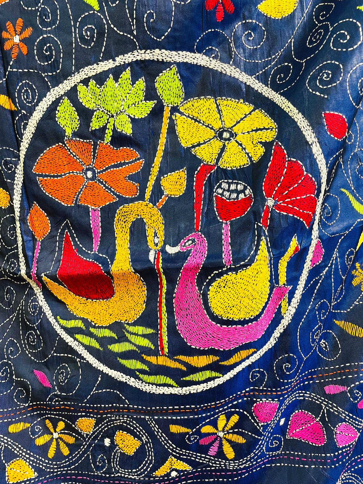 Close-up of hand-stitched swan medallion motif on ink blue Kantha saree