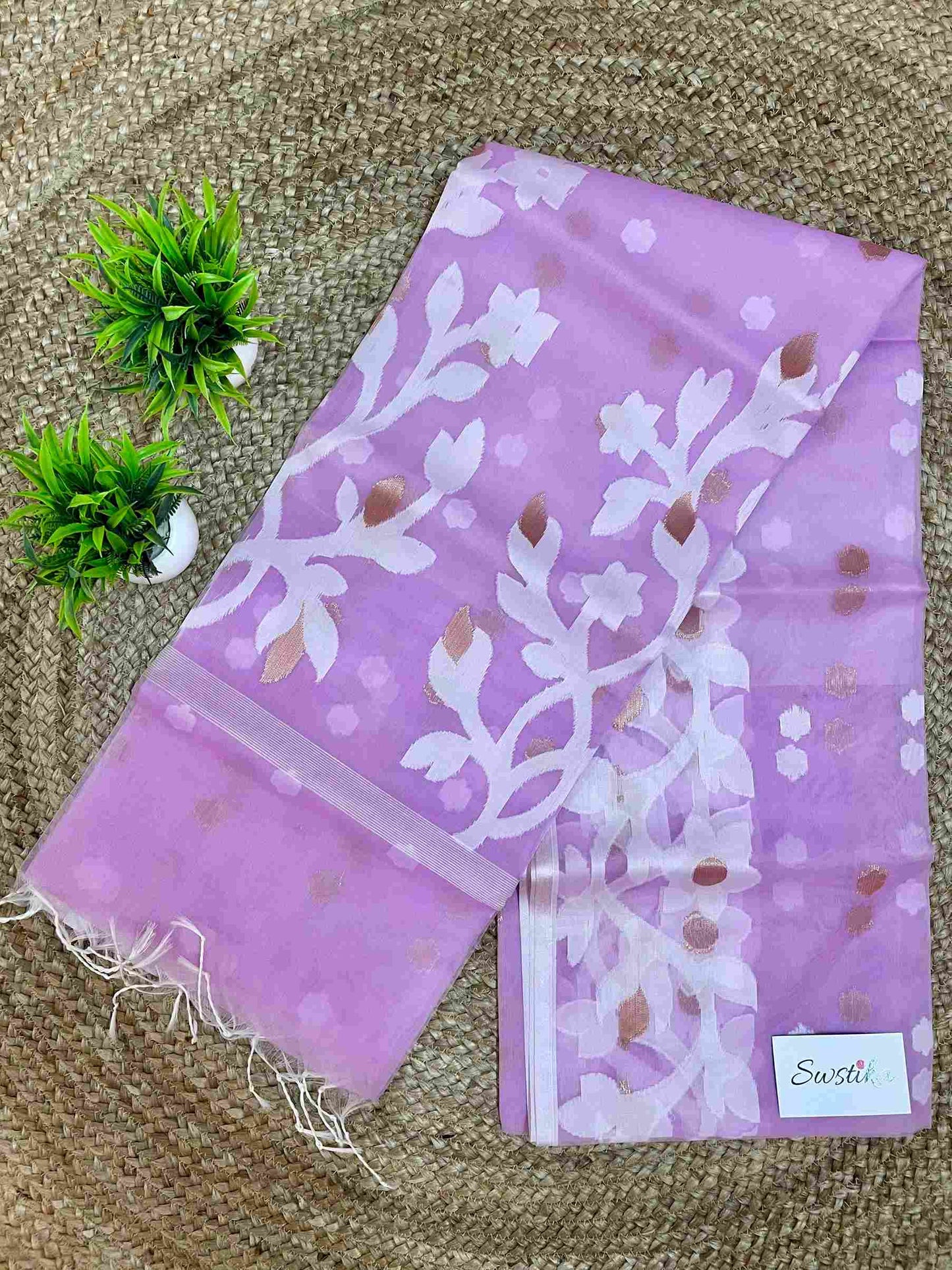 Close-up of Jamdani muslin saree motifs on Light Purple silk fabric