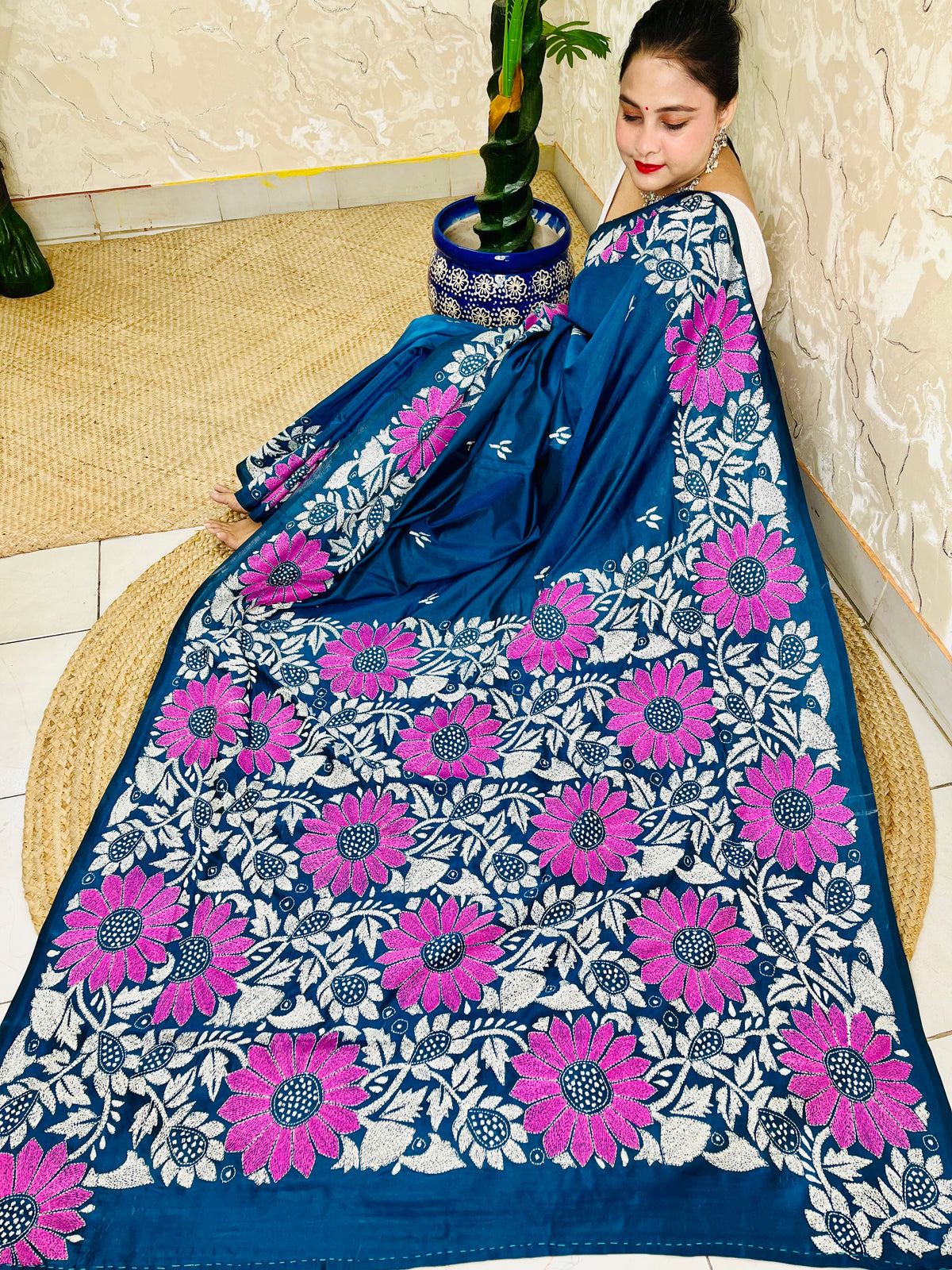 Seated pose in peacock blue Kantha stitch saree with sunflower pallu on Bangalore silk