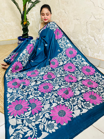 Seated pose in peacock blue Kantha stitch saree with sunflower pallu on Bangalore silk