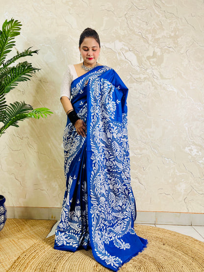 Front standing view of royal blue Kantha saree with branch and leaf pallu and plain body