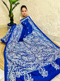 Seated close view of royal blue Kantha stitch saree pallu with dense white leaf work