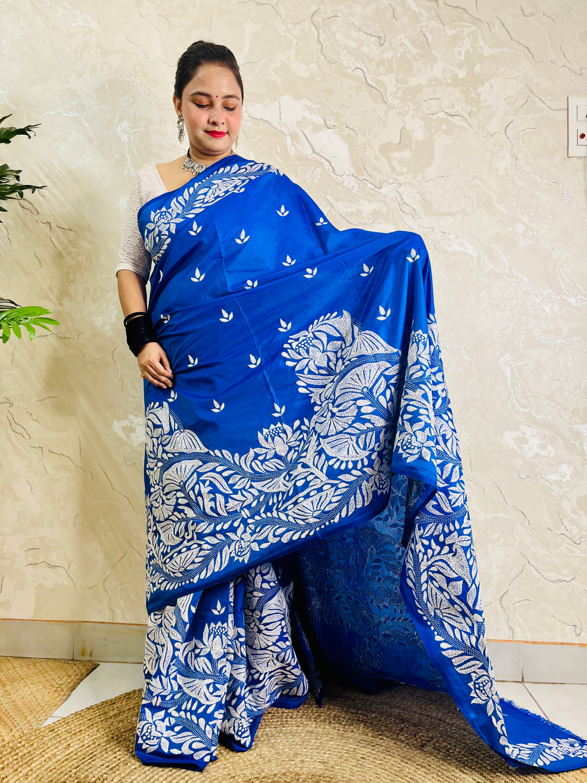 Front standing view of royal blue Kantha saree with branch and leaf pallu and plain body