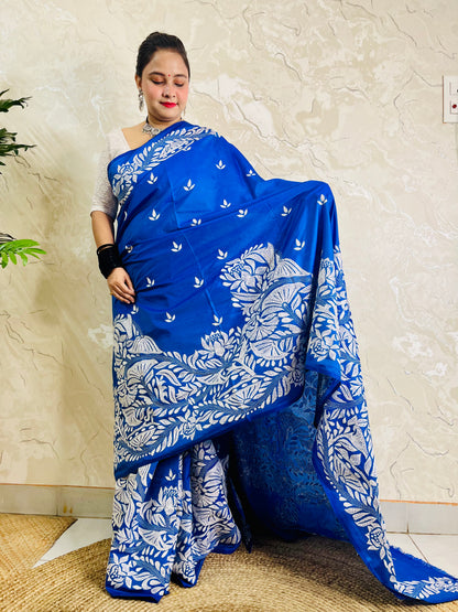 Front standing view of royal blue Kantha saree with branch and leaf pallu and plain body