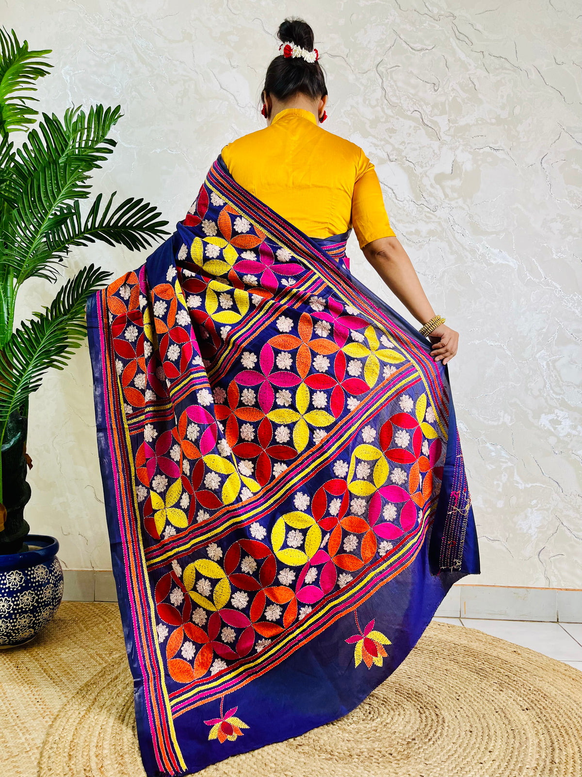 Deep indigo blue Kantha stitch saree with geometric pinwheel pattern, back standing view