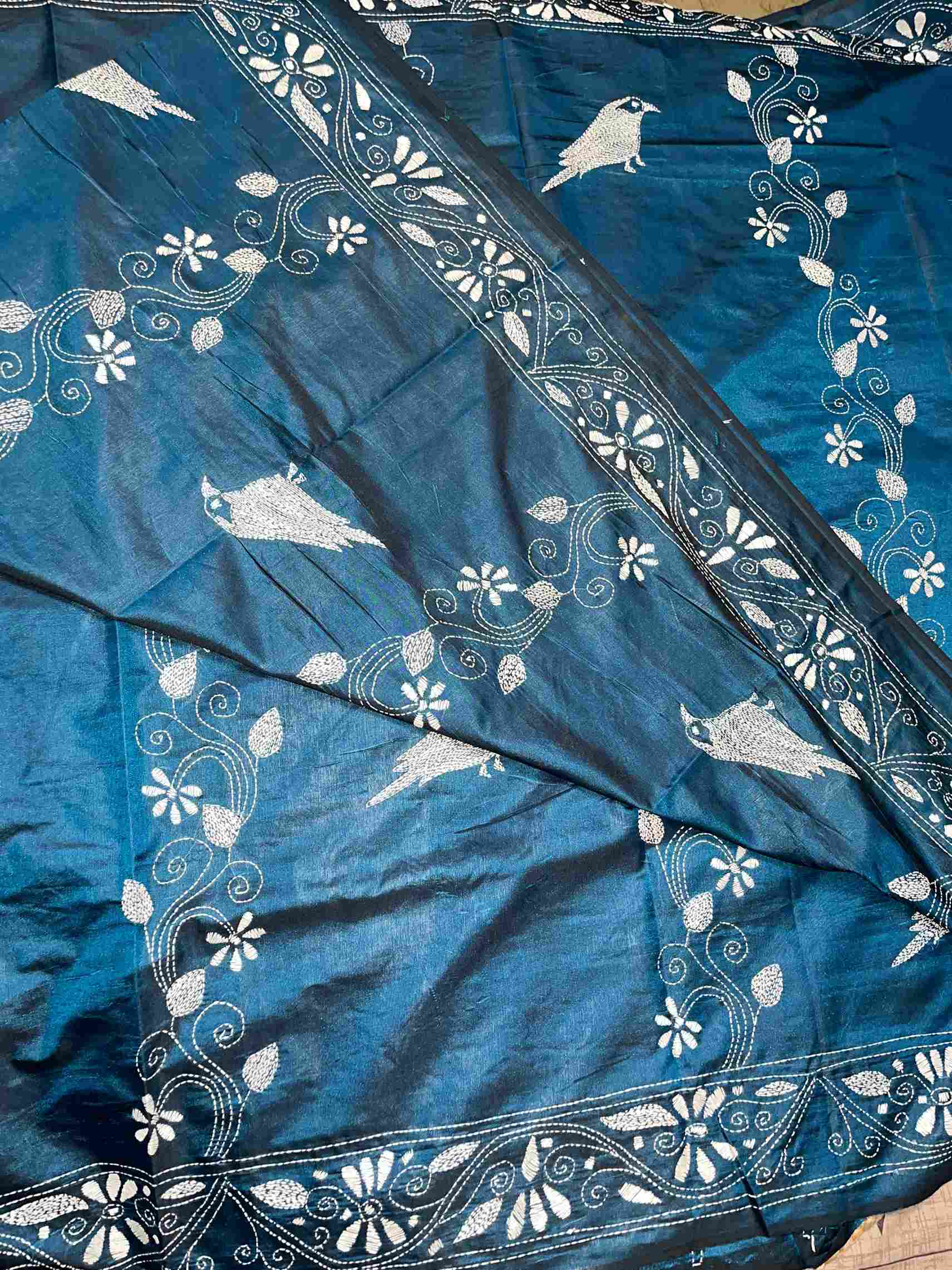 Close-up of Kantha stitch and bird motifs on Peacock Blue silk – traditional saree look by Desi Aadat