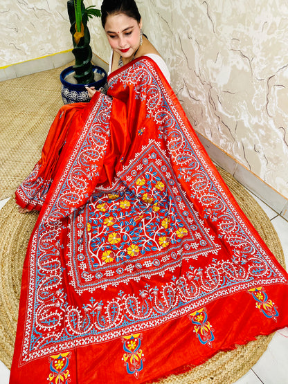 Top view of seated drape in vermilion saree with flower, leaf and paisley embroidery