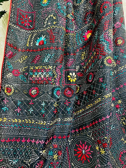 Detailed view of colourful Lambani thread work on black saree fabric