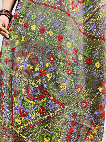 Close-up of dense floral Lambani hand stitch embroidery on moss green silk