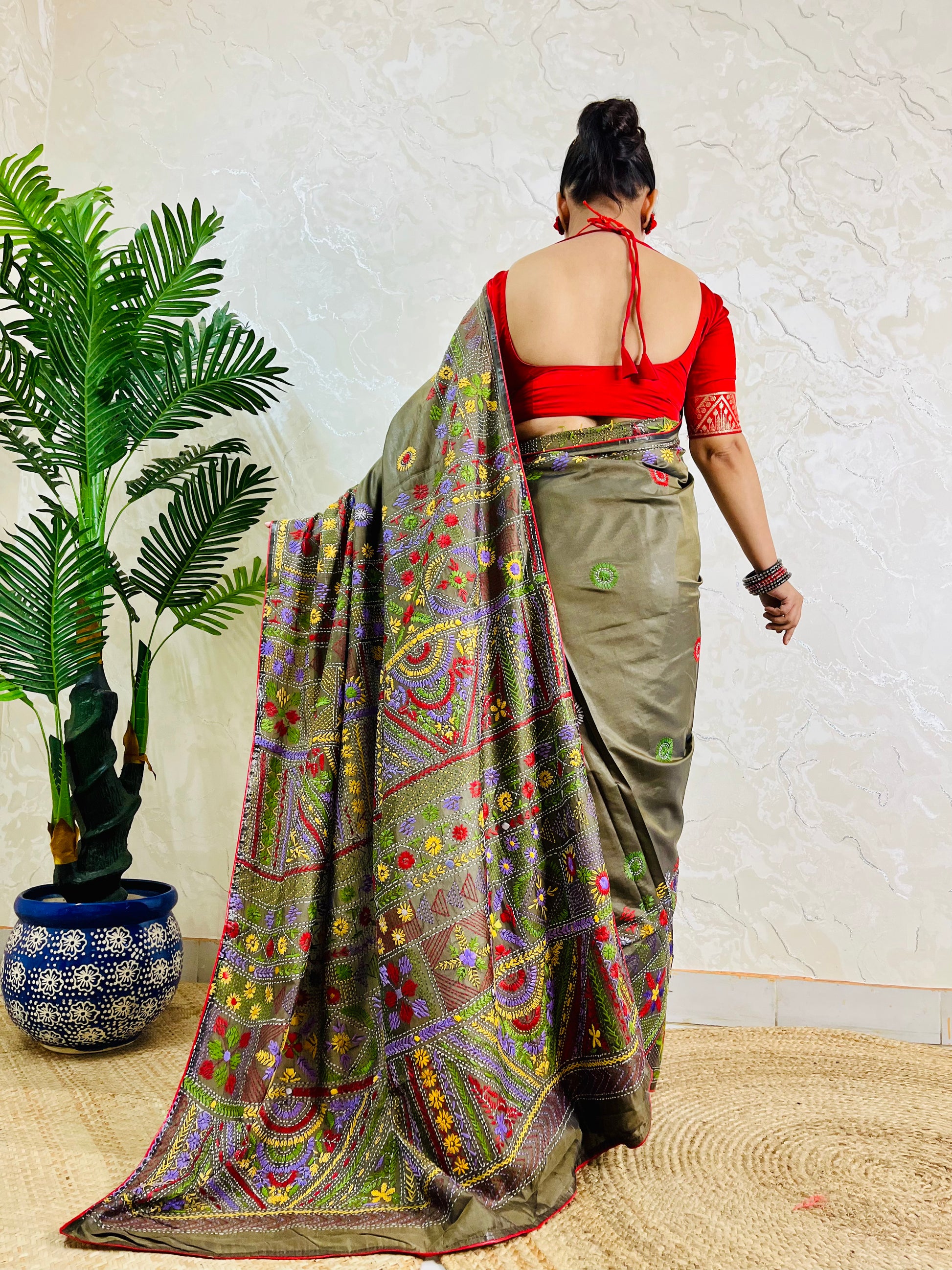 Back standing view of moss green Lambani hand embroidered saree