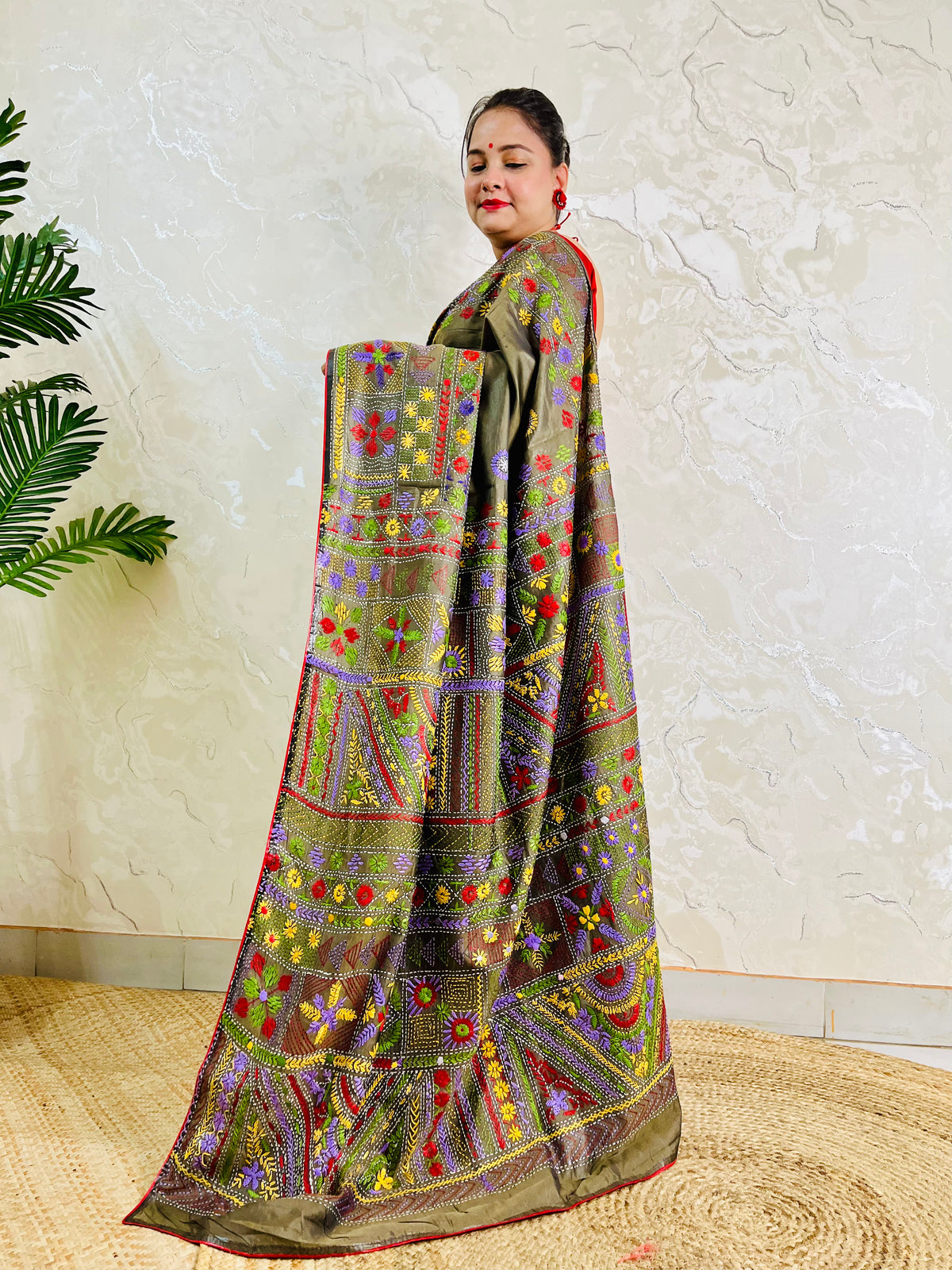Moss green Lambani hand stitch saree, side standing view with pallu draped