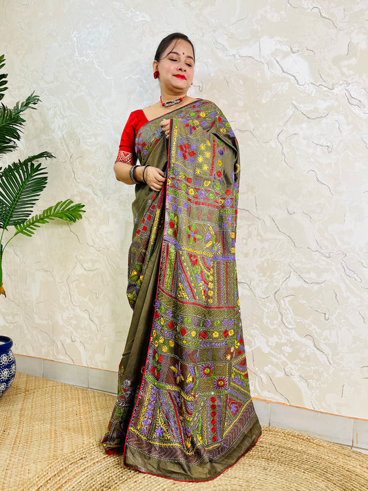 Moss green Lambani hand stitch saree, side standing view with pallu draped