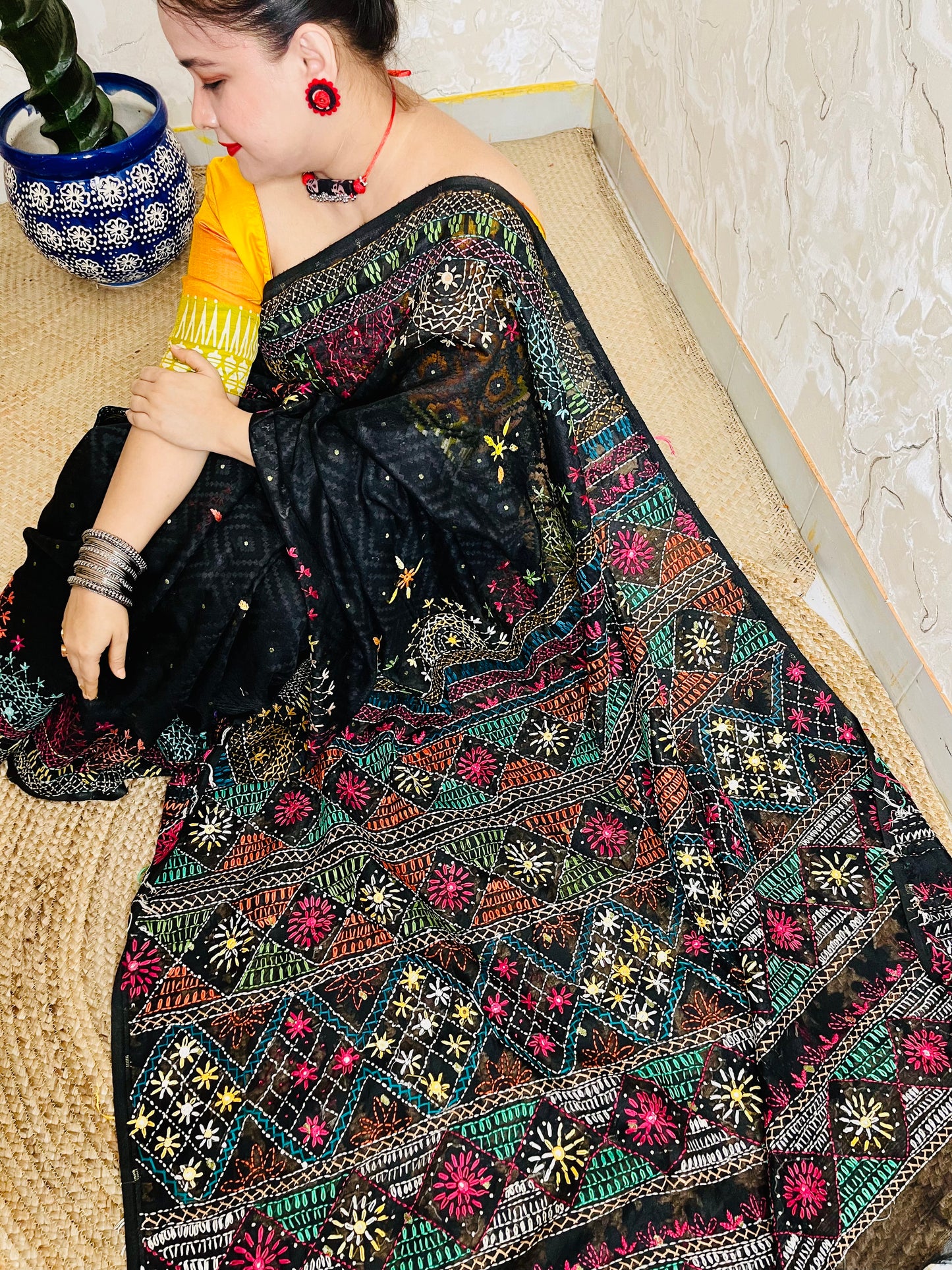Woman wearing black cotton Jamdani saree with traditional Lambani handwork