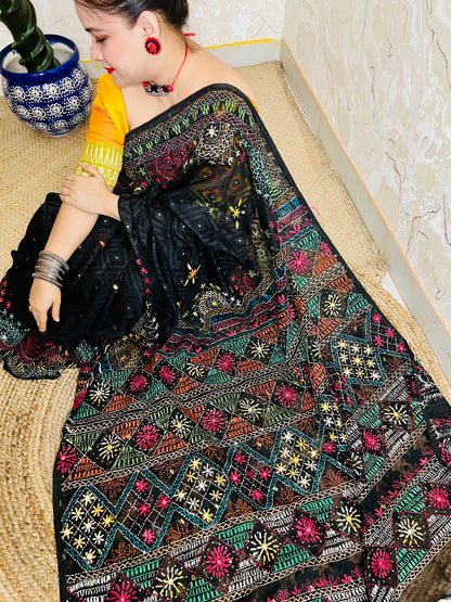 Woman wearing black cotton Jamdani saree with traditional Lambani handwork