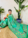 Close up of Lambani embroidery on pure tissue silk saree sea green
