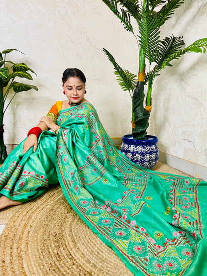 Close up of Lambani embroidery on pure tissue silk saree sea green