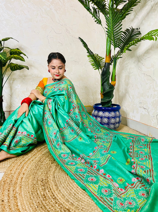 Close up of Lambani embroidery on pure tissue silk saree sea green
