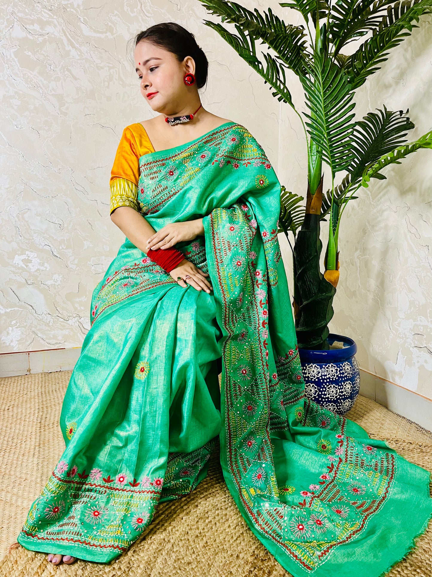 Elegant sea green tissue silk saree with colourful handcrafted threadwork