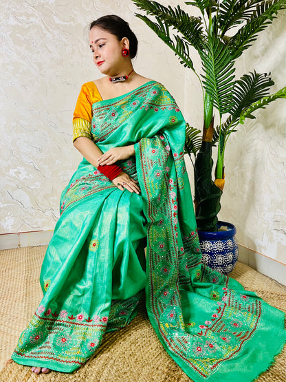 Elegant sea green tissue silk saree with colourful handcrafted threadwork