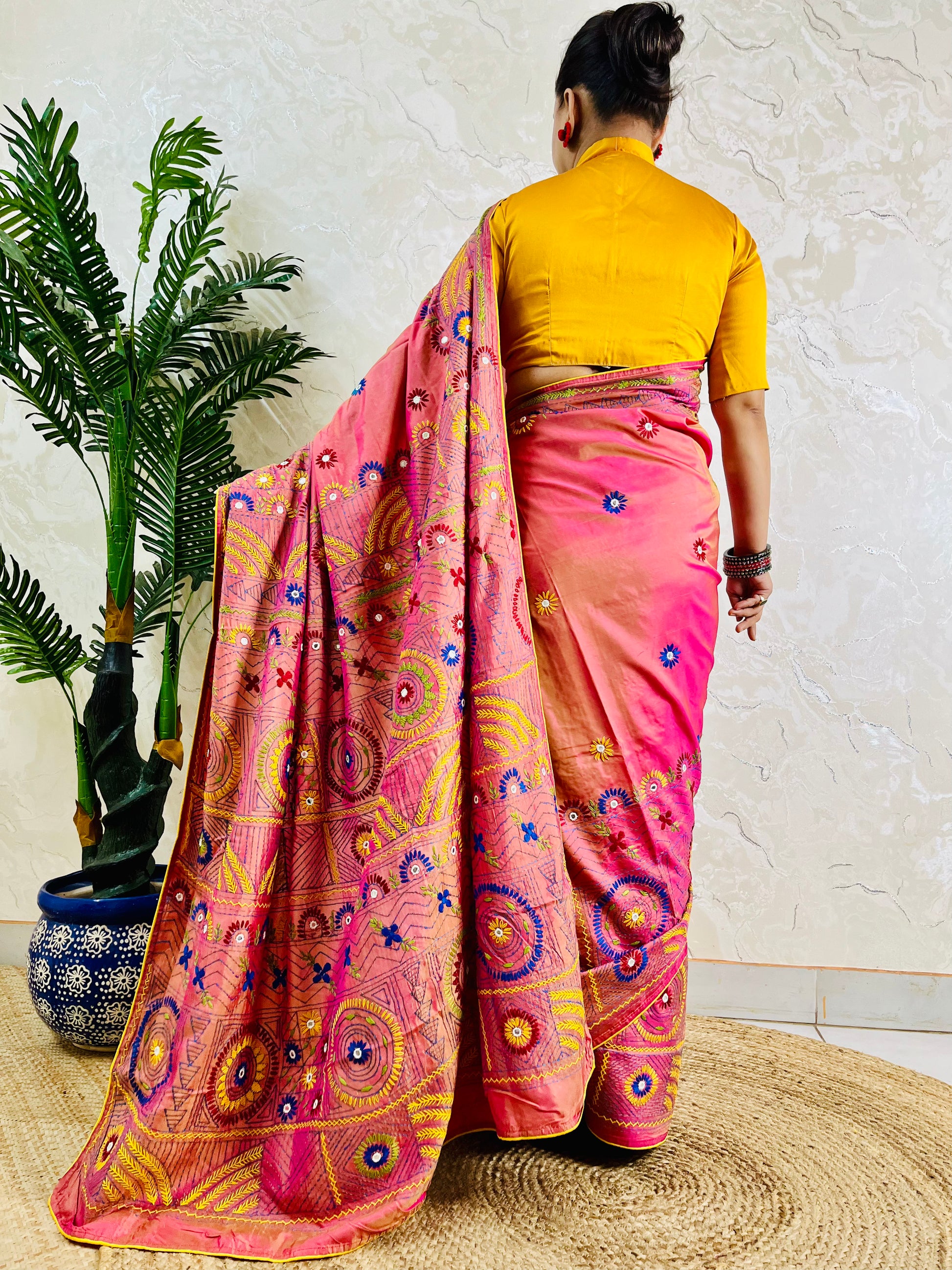 Coral pink Lambani mirror work saree, back standing view