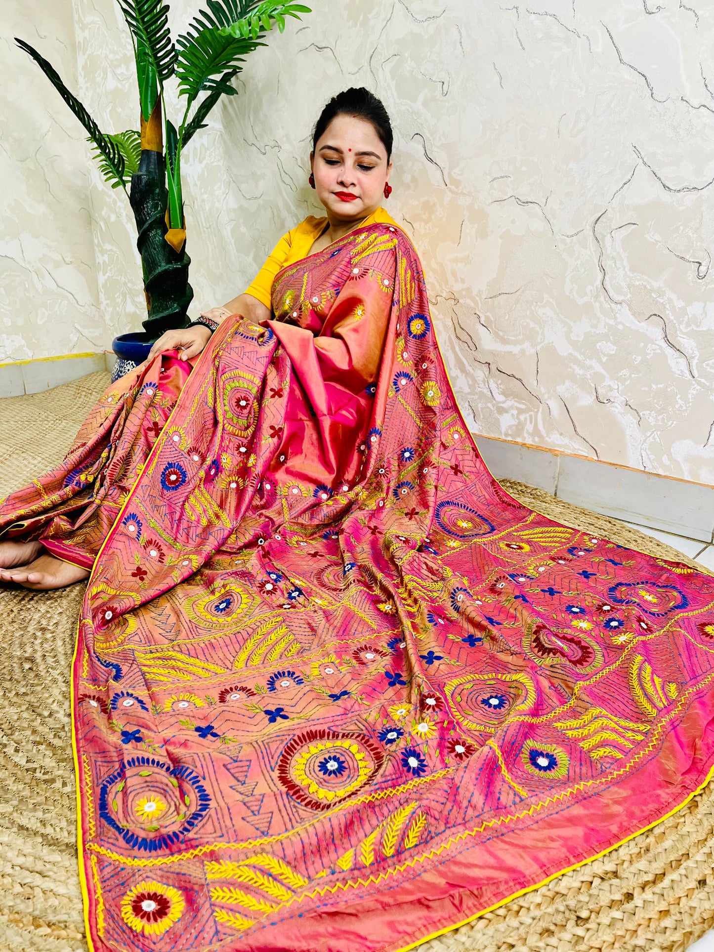 Coral pink Lambani stitch saree with mirror work, full seated drape view