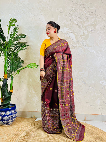 Woman wearing burgundy Bangalore silk saree with Lambani hand embroidery, side standing