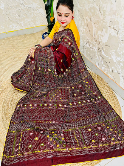 Burgundy Lambani mirror work saree draped, close-up seated view