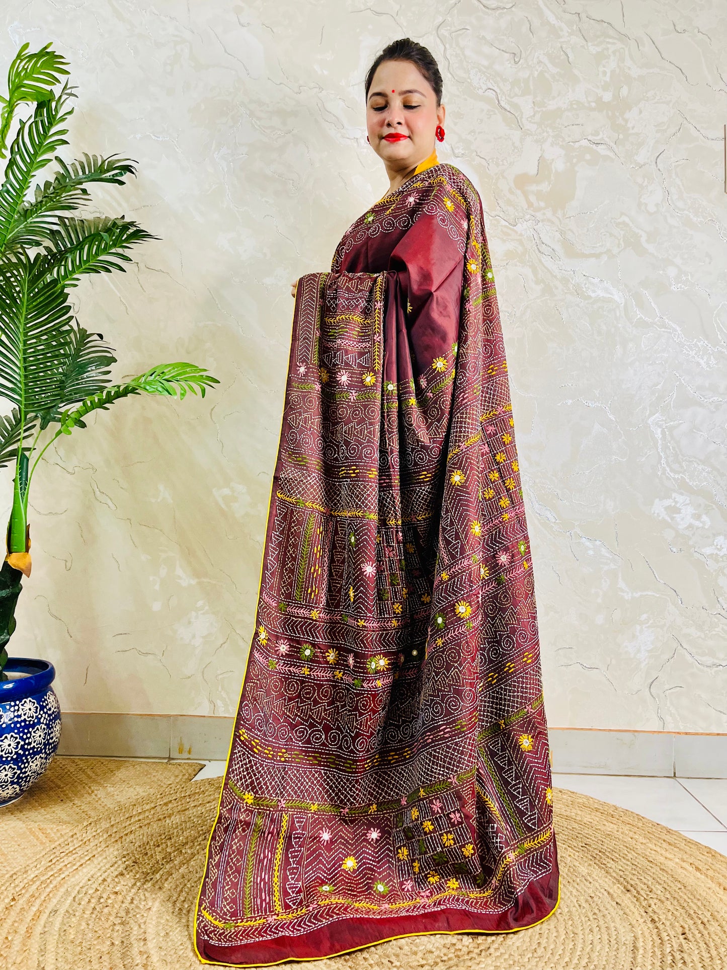 Woman wearing burgundy Bangalore silk saree with Lambani hand embroidery, side standing