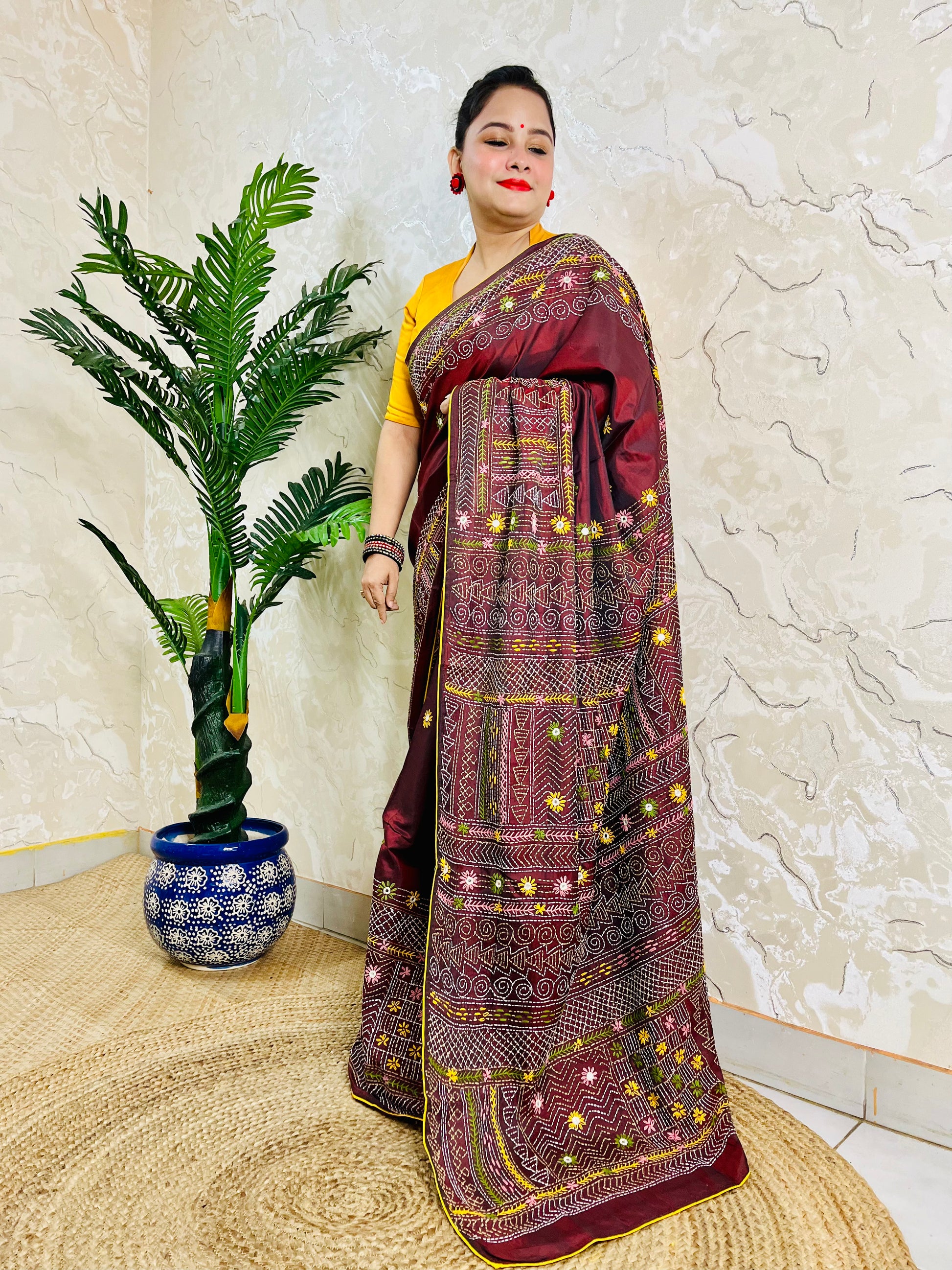 Woman wearing burgundy Bangalore silk saree with Lambani hand embroidery, side standing