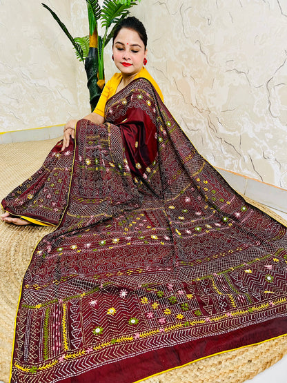 Burgundy Lambani mirror work saree draped, close-up seated view