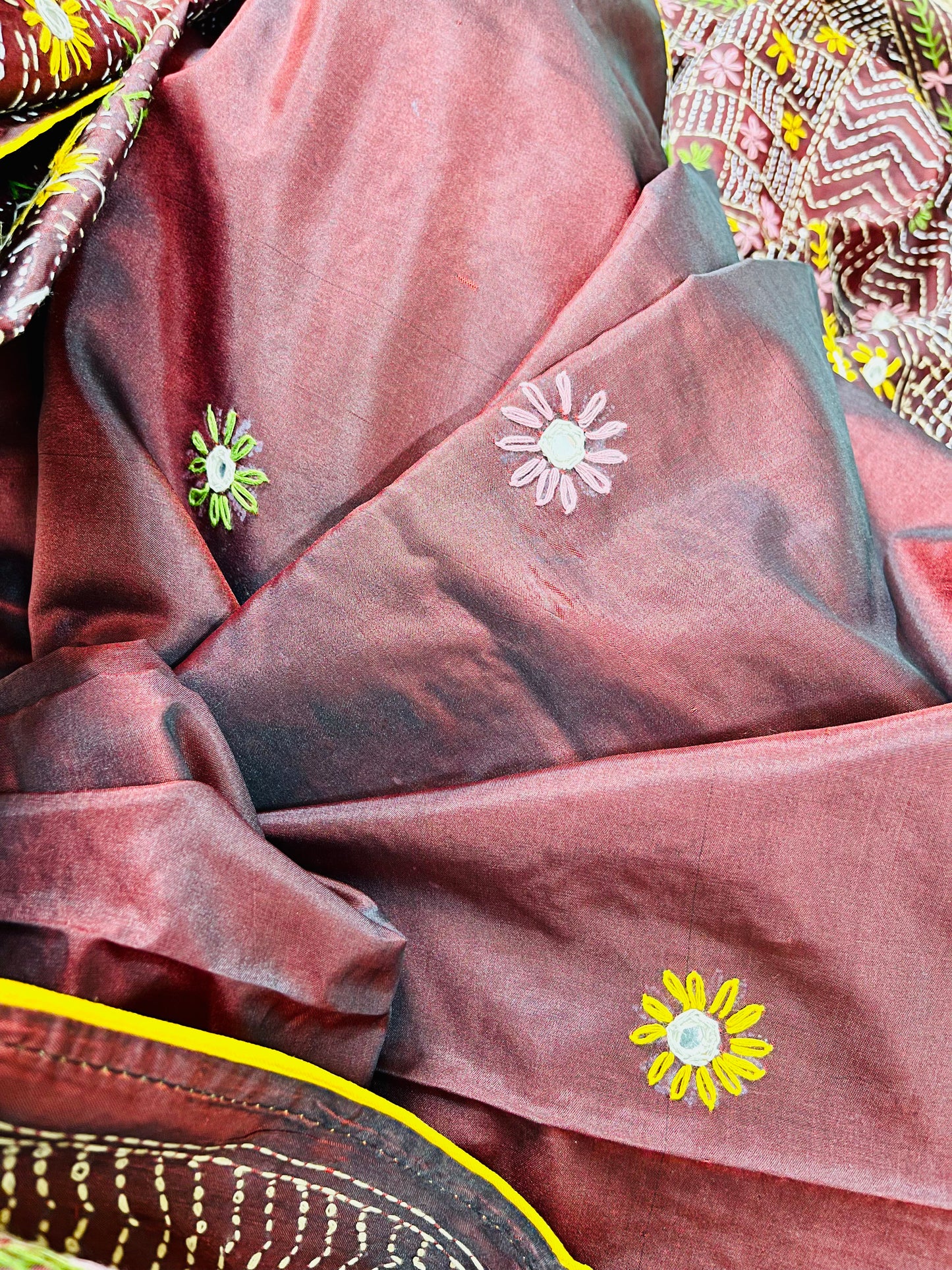 Close-up of mica mirror work and Lambani hand stitch embroidery on burgundy silk saree