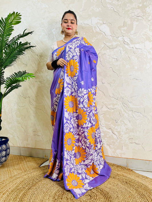 Front standing portrait of a model draped in the handcrafted lavender violet saree, showcasing the flowing sunflower motif pallu.