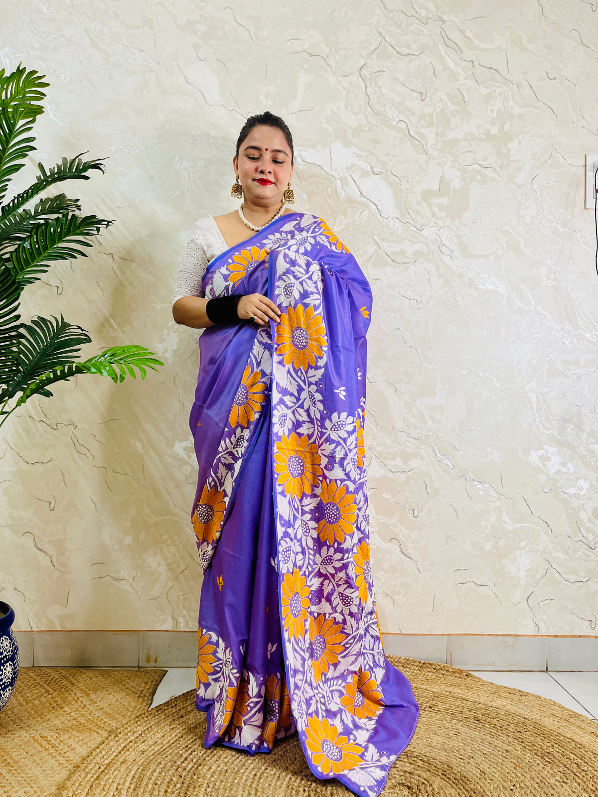 Front standing portrait of a model draped in the handcrafted lavender violet saree, showcasing the flowing sunflower motif pallu.