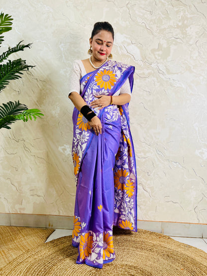 Front standing portrait of a model draped in the handcrafted lavender violet saree, showcasing the flowing sunflower motif pallu.