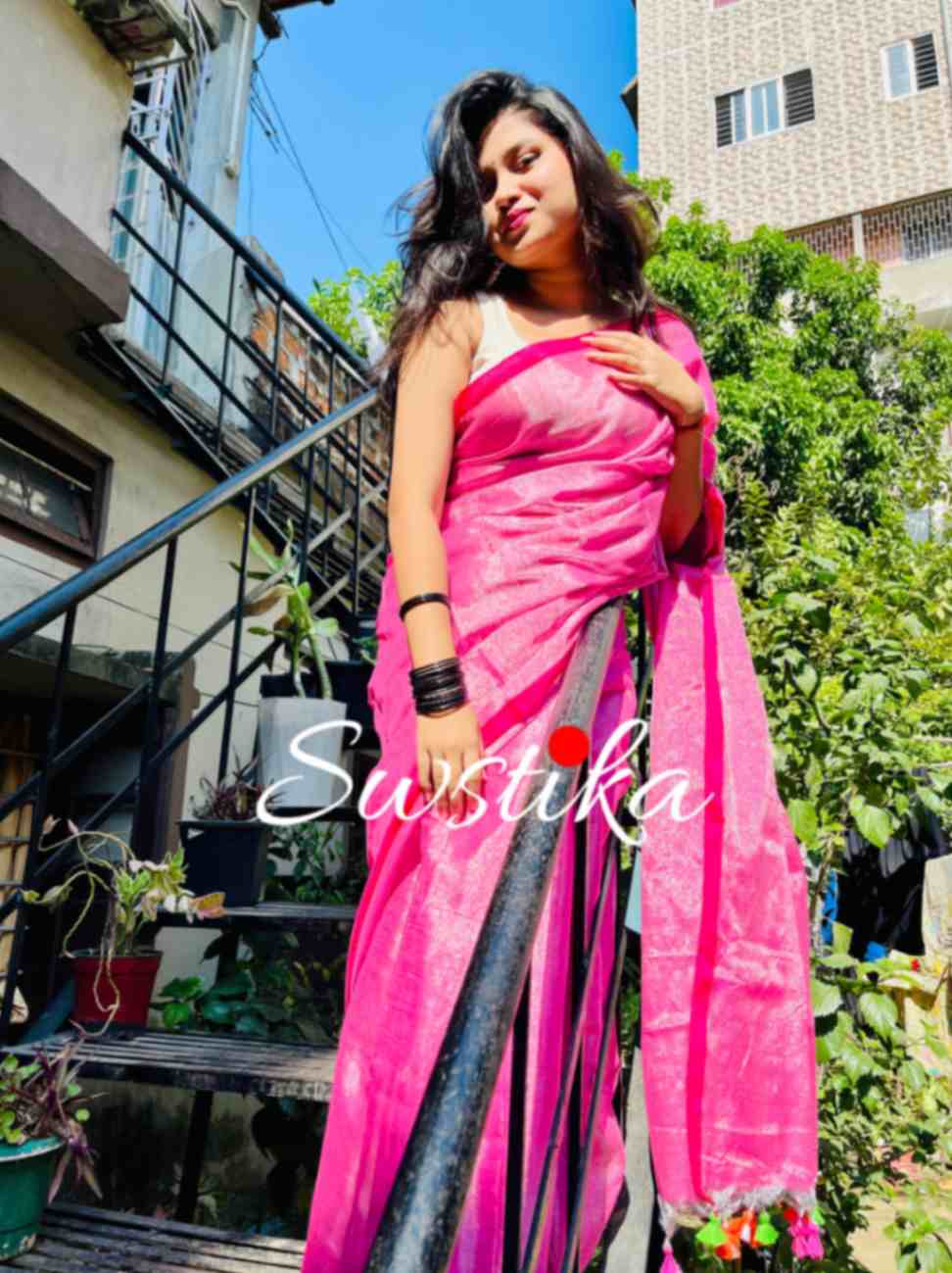 Close-up of silver zari on Pink linen saree fabric
