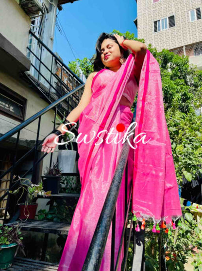 Graceful woman in Pink linen saree showcasing Desi Aadat’s handwoven design
