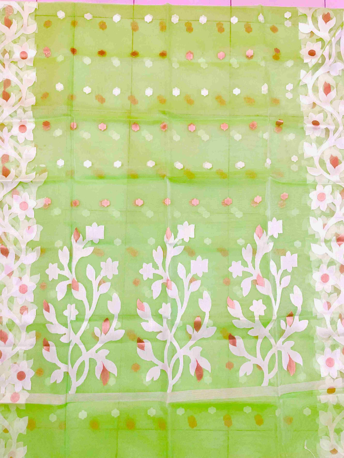 Close-up of Jamdani muslin saree motifs on Banana Leaf Green silk fabric