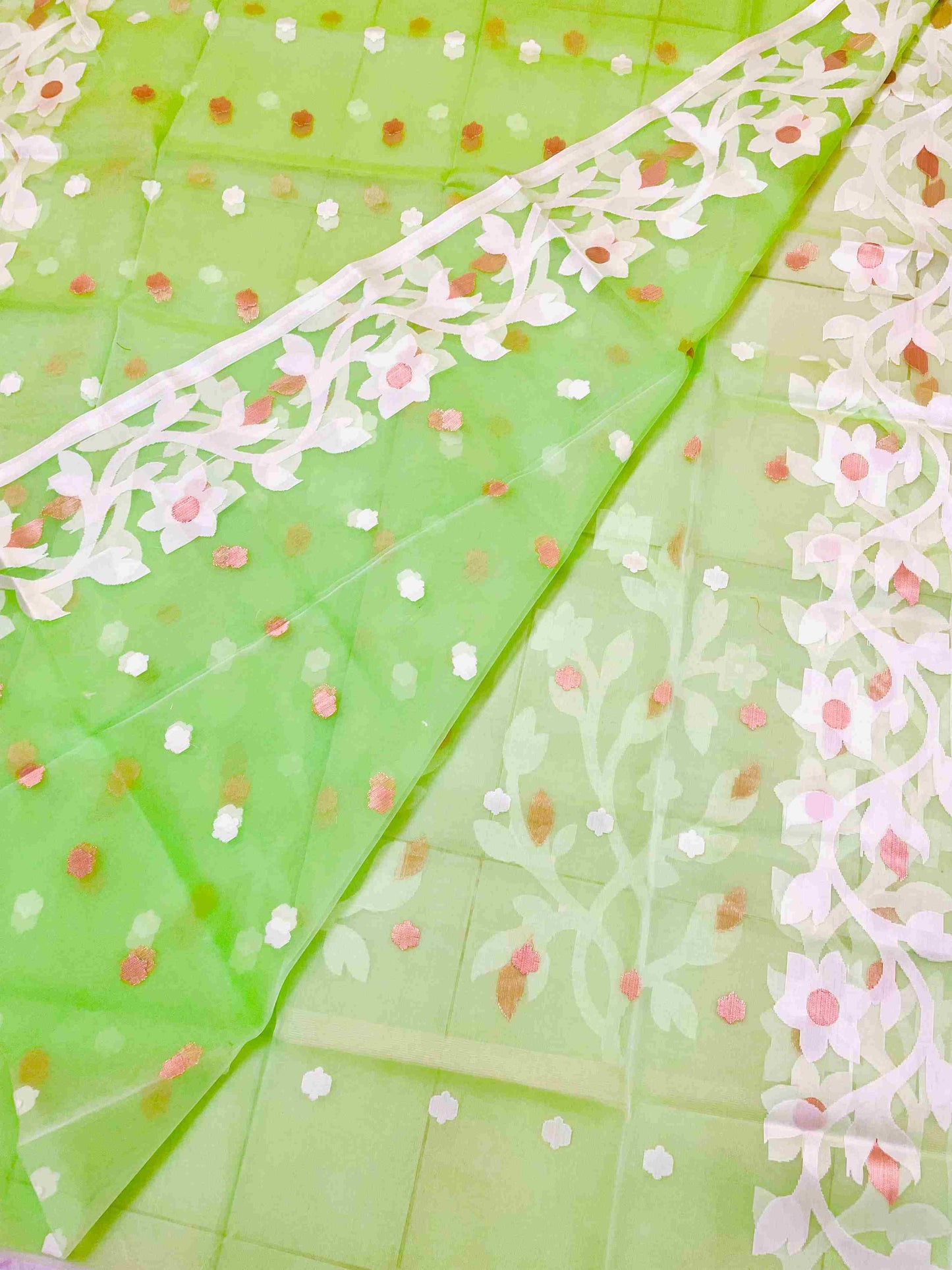 Close-up of Jamdani muslin saree motifs on Banana Leaf Green silk fabric