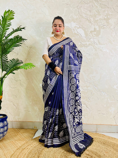 Full front view of a woman modeling the navy blue handcrafted saree, revealing the leaf motif body and multi-striped border work.