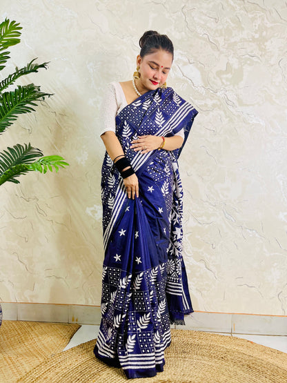 Full front view of a woman modeling the navy blue handcrafted saree, revealing the leaf motif body and multi-striped border work.
