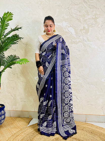 Full front view of a woman modeling the navy blue handcrafted saree, revealing the leaf motif body and multi-striped border work.