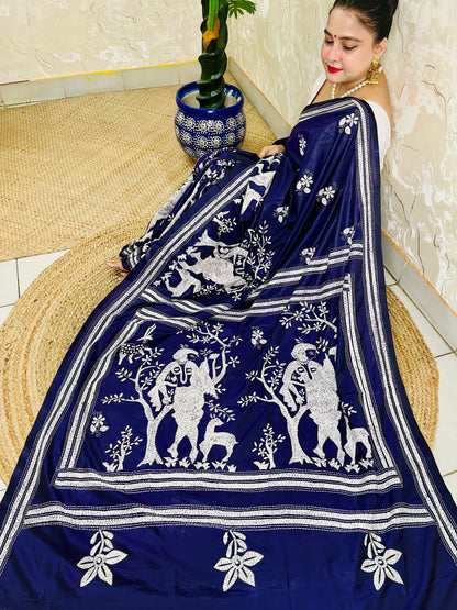Top-down view displaying the full village landscape Katha stitch artwork spread across the deep navy blue silk drape.