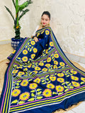 Seated drape of navy blue Kantha stitch saree with yellow sunflower motifs and scattered small flowers