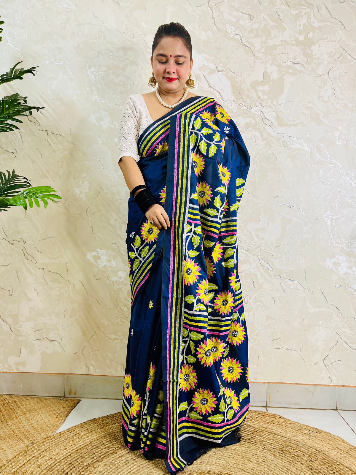 Front standing view of navy blue sunflower Kantha stitch saree with striped pallu on Bangalore silk