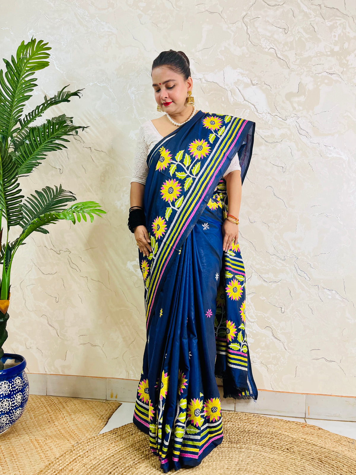 Front standing view of navy blue sunflower Kantha stitch saree with striped pallu on Bangalore silk