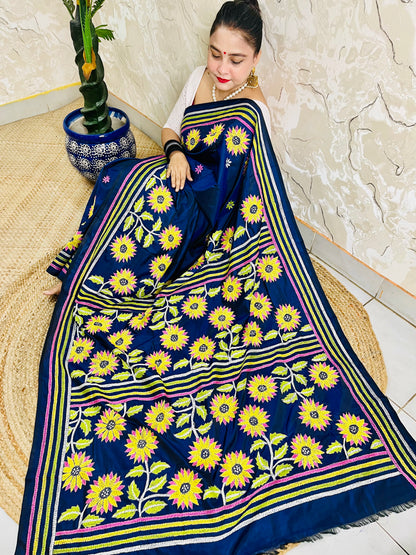Seated drape of navy blue Kantha stitch saree with yellow sunflower motifs and scattered small flowers