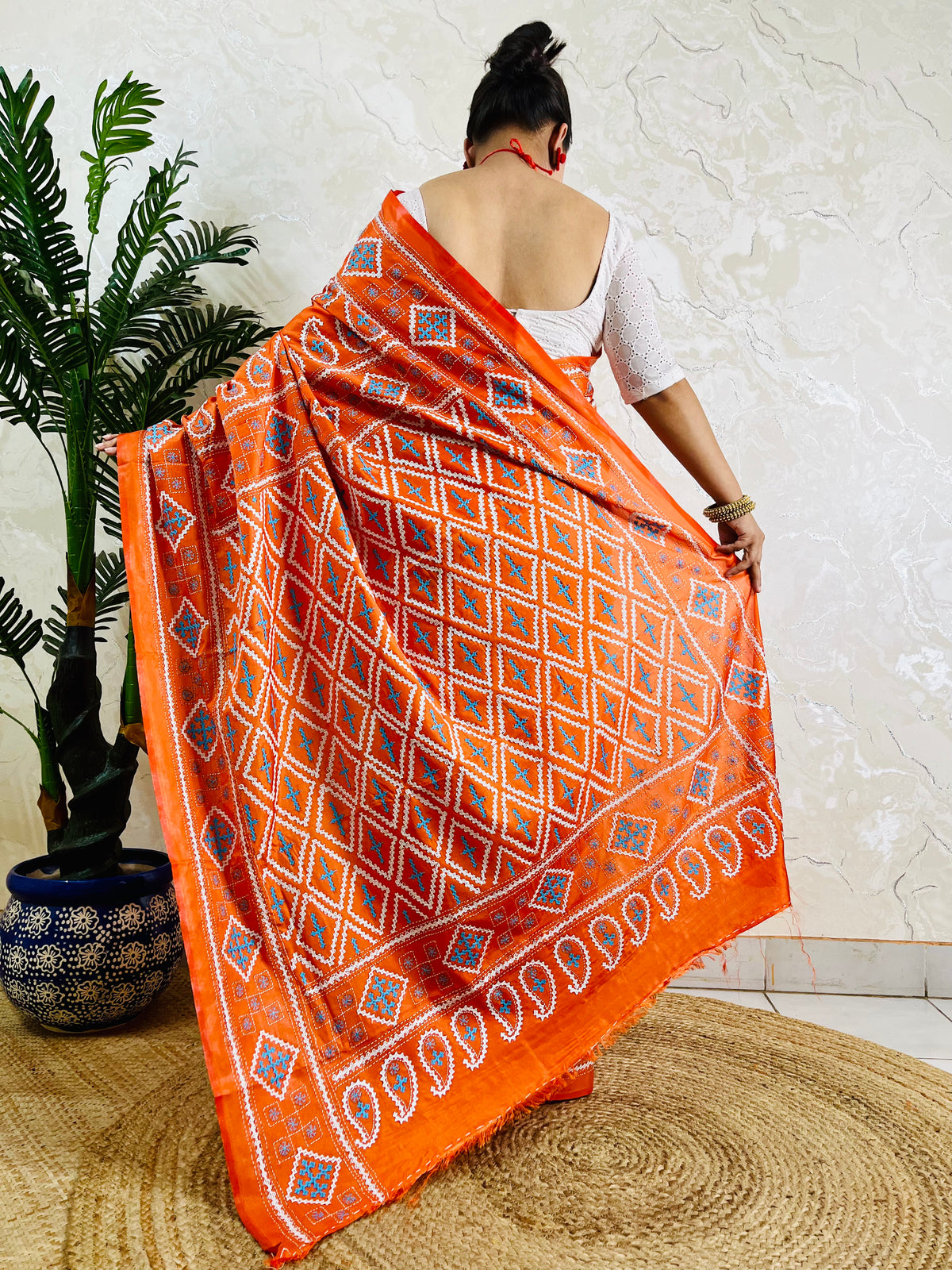 Back view of orange Kutch work saree with paisley pallu on Bangalore silk